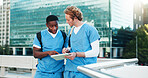 Medical, students and men on tablet in city for education, help and discussion. Digital technology, outdoor and healthcare nurses reading schedule, exam and team learning for university on rooftop