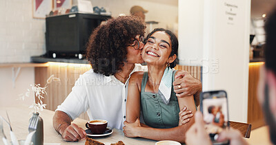 Buy stock photo Couple, happy and kiss in picture in restaurant for coffee date memory, relationship support and social media post. Gen z people, smile and photography in cafe for bonding, romance and connection