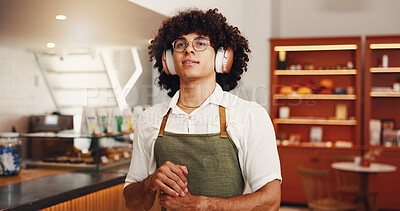 Buy stock photo Music, man and barista with headphones in cafe, streaming radio and idea for hip hop playlist in startup. Thinking, waiter and listening to sound, reflection and daydreaming for vision in coffee shop