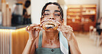 Cafe, happy and woman pastry eating for breakfast with snack, meal and hungry with craving. Coffee shop, restaurant and person with croissant, baked confectionery and bite delicious food for dessert