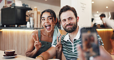 Buy stock photo Photography, excited and couple in cafe on date with memory, bonding or social media post. Peace sign, happy and man with woman in coffee shop for profile picture in morning at restaurant together