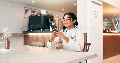 Buy stock photo Cafe, woman and smile with smartphone for chat, online communication and comment on social media. Coffee shop, female person and customer with mobile for app, dating website and notification for text