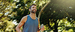 Smile, active man and earpods for running outdoor of cardio exercise, endurance training and marathon practice. Male athlete, runner and sports workout, fitness performance and listening to podcast