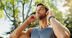 Fitness, nature and man relax with earphones for workout music, thinking and running break. Athlete, runner and listening to exercise podcast for marathon training, cardio wellness or streaming radio