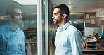 Business, thinking and man with window, decision and problem solving with ideas for project. Person, copywriting and employee in office, thoughtful and confused with doubt for proposal or daydreaming