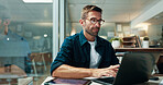 Businessman, typing and laptop in office with night, overtime and writer at publishing agency. Proposal, journalist professional and deadline for news article, reporter and employee in workplace