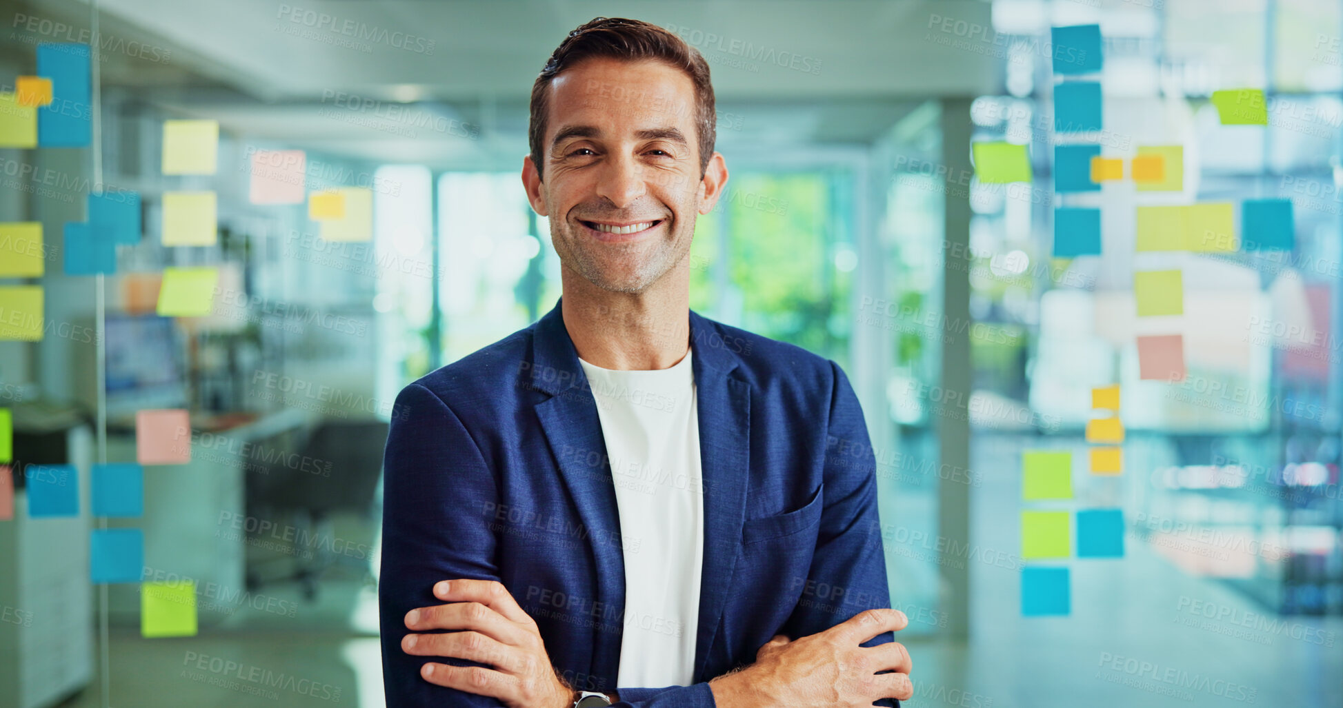 Buy stock photo Man, happy and glass wall with arms crossed by notes at office in portrait, solution or moodboard at startup. Mature person, pride and excited by window, career or mindmap at creative agency in Spain