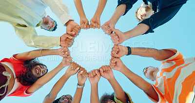 Buy stock photo Blue sky, below and hands of people in circle for support, solidarity and community outdoors. Diversity, students and group of friends with fist pump in huddle for school, university and college