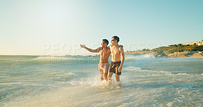 Buy stock photo Beach, fun and friends in ocean on vacation, adventure or holiday together for travel. Pointing, happy and men swimming in sea water for activity or hobby on tropical weekend trip with freedom.