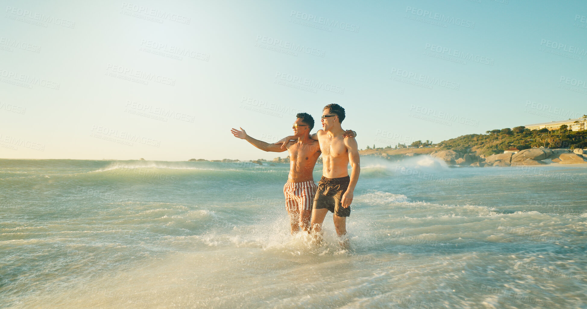 Buy stock photo Beach, fun and friends in ocean on vacation, adventure or holiday together for travel. Pointing, happy and men swimming in sea water for activity or hobby on tropical weekend trip with freedom.
