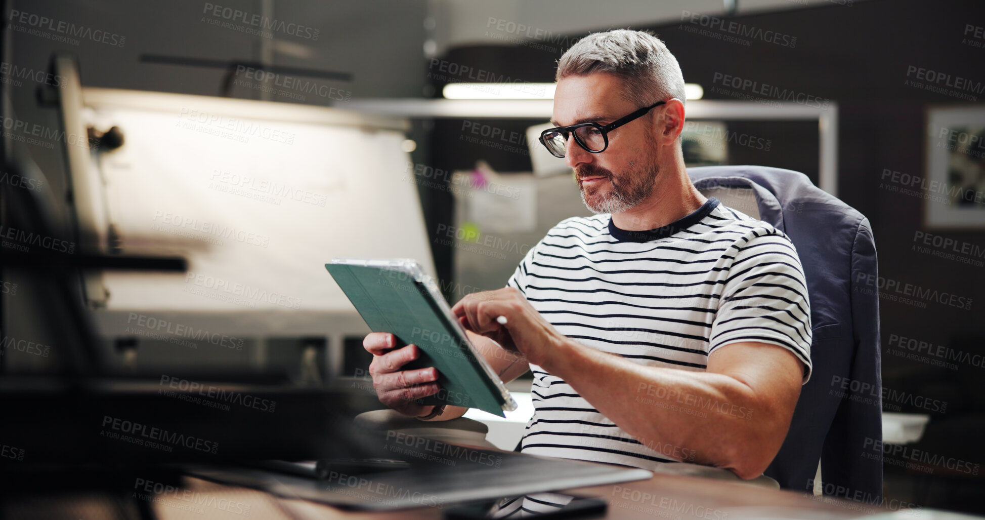 Buy stock photo Online, night and mature man with tablet, office and creative for web design with software or browsing. Overtime, graphic designer and person with glasses in business, deadline and tech for project