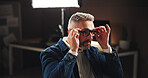 Business, night and man in office, glasses and thinking with problem solving for eyesight, creative and deadline. Mature person, graphic designer and artist in workplace, clear vision and pressure