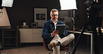 Live stream host, recording and man with tablet in home studio for talk show, online interview or podcast. Filming set, lights and mature journalist with digital script for news broadcast or research