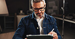 Mature man, writing or night with tablet for creative design, development or online project at office. Male person, digital artist or designer working late with technology for app or content creation