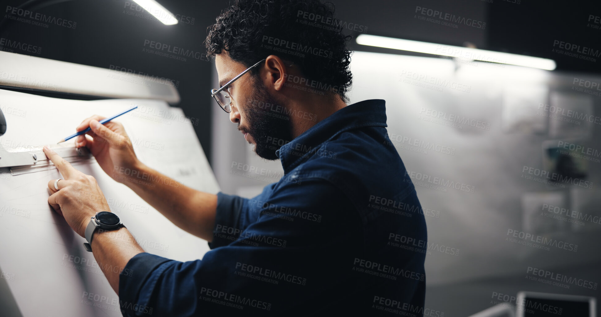 Buy stock photo Sketching, creative and man artist in studio at night with deadline for animation illustration. Board, equipment and male graphic designer drawing for visual character prototype at agency in dark.