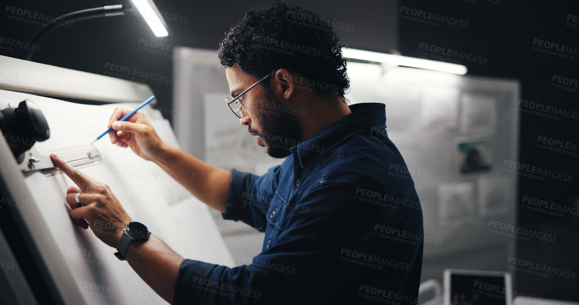 Buy stock photo Drawing, creative and man artist in studio at night with deadline for animation illustration. Board, equipment and male graphic designer sketching for visual character prototype at agency in dark.