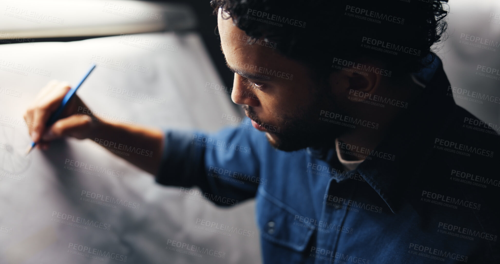 Buy stock photo Sketching, creativity and man artist in studio at night with deadline for animation illustration. Board, equipment and male graphic designer drawing for visual character prototype at agency in dark.