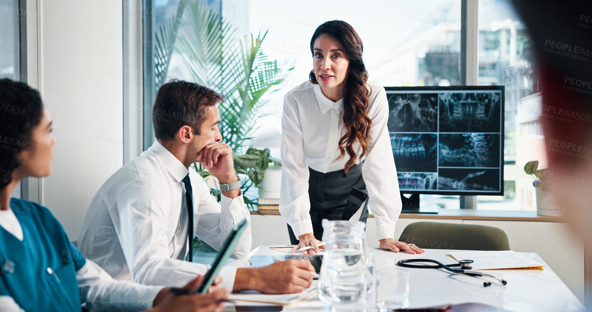 Buy stock photo Woman, doctor or discussion with x ray on screen for meeting or planning surgery in boardroom. Female person, speaker or medical team with CT scan or display for health exam, diagnosis or results