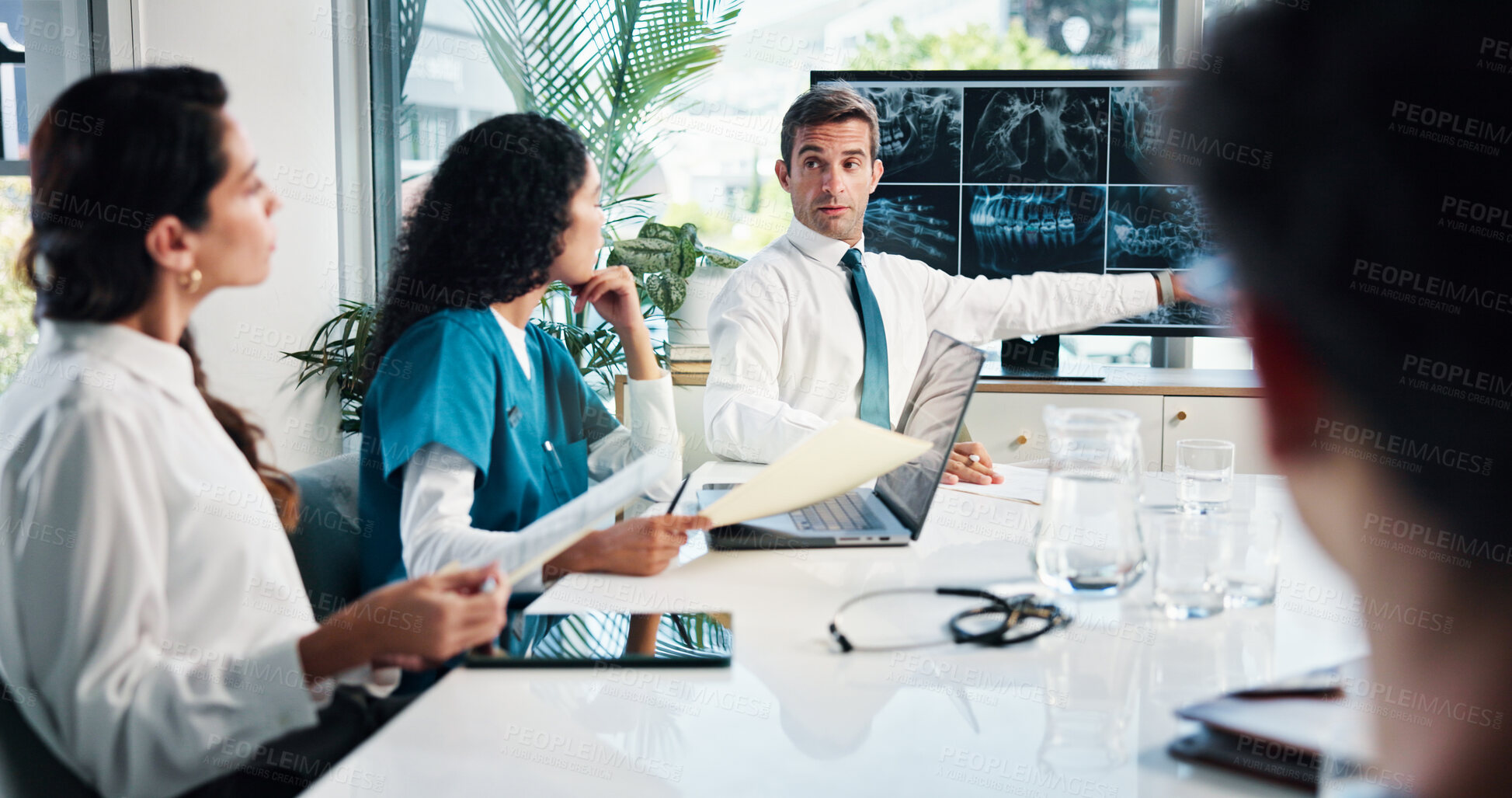 Buy stock photo Man, doctor or meeting with x ray on screen for planning surgery or discussion in boardroom. Male person, speaker or medical team with CT scan or display for health exam, diagnosis or clinic results