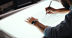 Man, hands and designer with drawing for car prototype, modeling or graphic design on light table. Male person, mechnical engineer or digital sketch with 2D vehicle, blueprint or automobile project