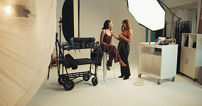 Buy stock photo Woman, model and photographer discussion in studio for photoshoot, photography and production. Behind the scenes, creative and designer in media agency with cast, lighting and brand advertising