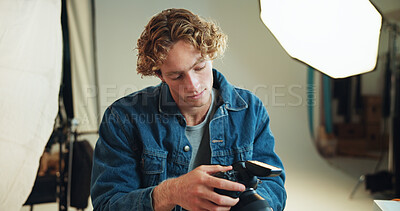 Buy stock photo Man, photographer and check camera in backstage for photoshoot results, catalog and selection. Person, tech or lens focus for film production, editing process and picture quality of creative industry