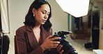 Woman, photographer and check camera in backstage for photoshoot results, catalog and selection. Person, tech quality and lens focus for filming production, editing picture and photography industry