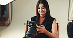 Smile, woman and photographer check on camera for photoshoot results, catalog and selection. Person, tech and lens focus for filming production, editing picture and photography industry in backstage