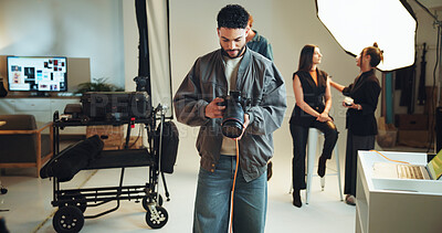 Buy stock photo Camera, photography and review with man in studio for checking results of photoshoot production. Backstage, getting ready or media with makeup artist, model and photographer on set for filming