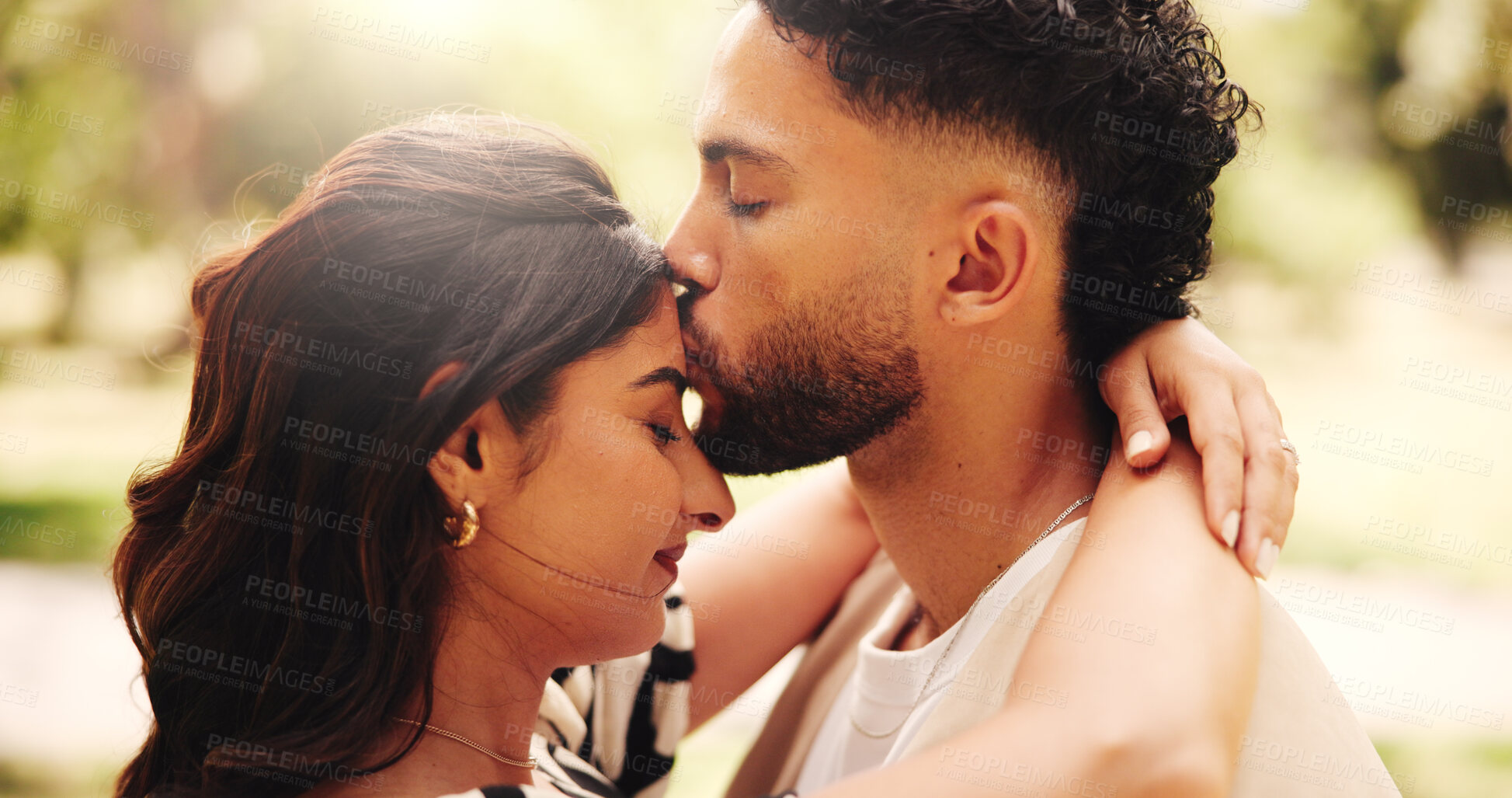 Buy stock photo Forehead, kiss and couple on date, bonding and romance for people in nature, outdoor and anniversary. Relationship, woman and affection for man, love and happy for valentines day, smile or commitment