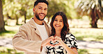 Portrait, happy and couple with heart shape, park and romance for people with smile, love and together. Outdoor, man and affection for woman in nature, gesture and commitment for relationship or date