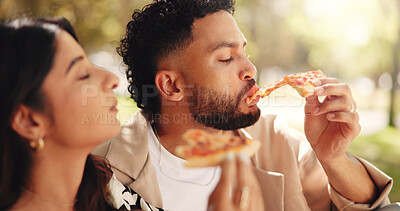 Buy stock photo Couple, picnic and eating pizza at park together for romantic date, lunch and bonding for relationship. Man, woman and share fast food outdoor, hungry or enjoy takeaway to relax with partner for love