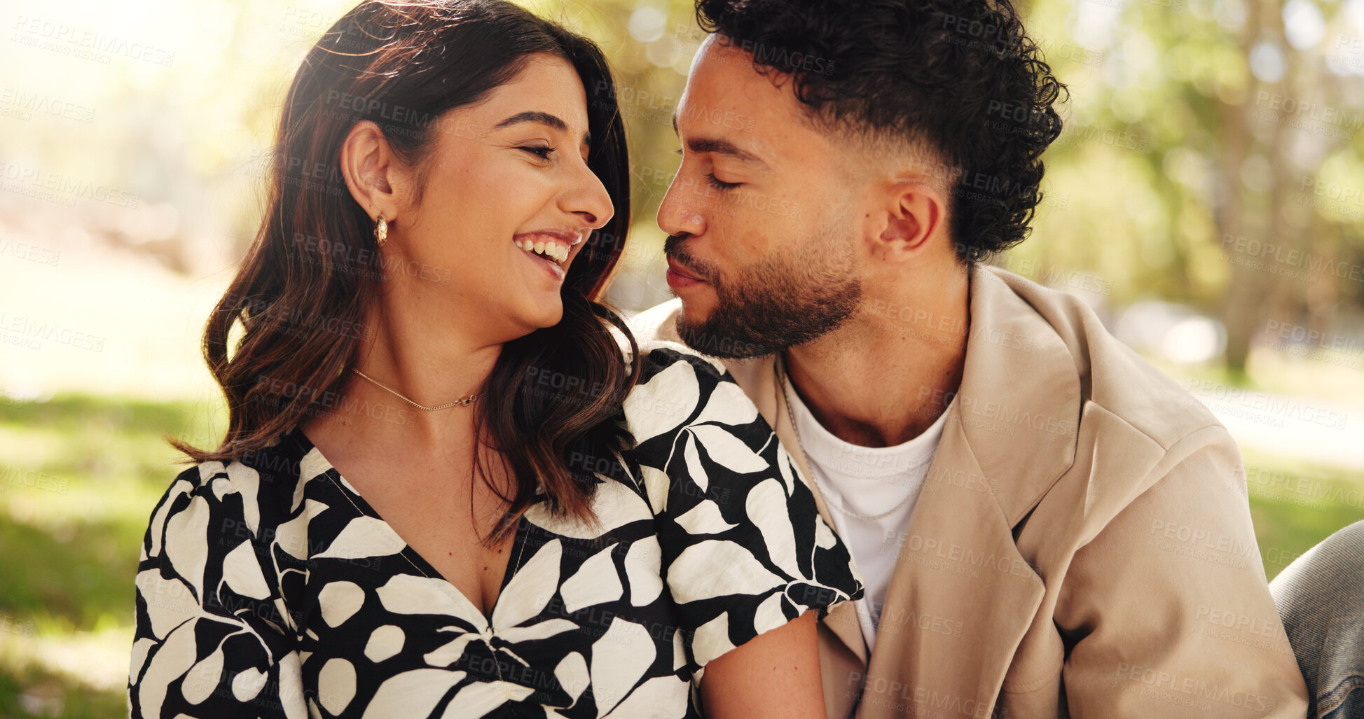 Buy stock photo Outdoor, bonding and couple on date, picnic and joke for conversation in nature, smile or relationship. Embrace, man and romance with woman on anniversary, laughing and people with commitment or park