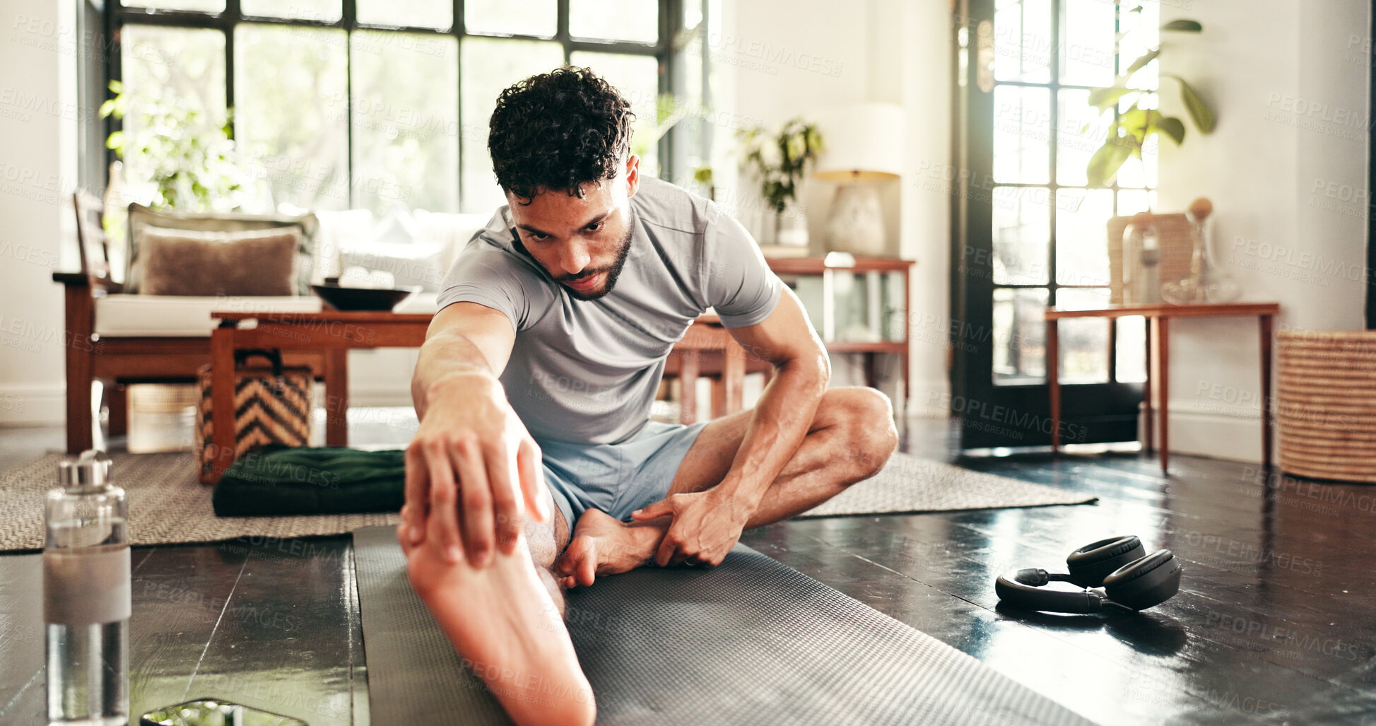 Buy stock photo Man, fitness and stretching in home for warm up, workout or exercise for training or leg muscle. Endurance, goal and athlete person for cardio, wellness and balance on floor with mat for challenge