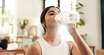 Break, drinking water and exercise with woman in home for fitness, hydration or wellness workout. Bottle, relax and training with thirsty person in apartment living room for health or pilates