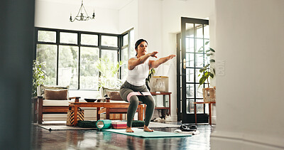 Buy stock photo Fitness, woman and squat with resistance band in home for hamstring training, workout glutes or balance. Exercise legs, muscle and person crouch for body strength, stretching and wellness for pilates