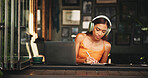 Writing, headphones and laptop with student in cafe on campus for college research, education or learning portal. University, music and notebook with woman in restaurant for online scholarship