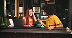 Date, laptop and talking with couple in coffee shop together for bonding, love or romance. Computer, conversation and smile of woman with man in cafe or restaurant for hospitality, relax or service