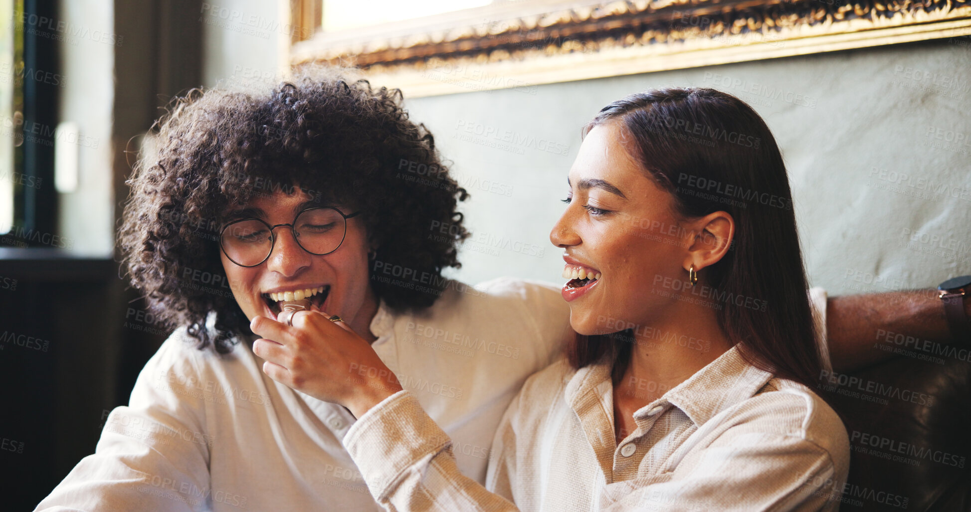 Buy stock photo Date, feeding and food with couple in coffee shop together for bonding, love or romance. Bite, happy or snack with man and woman in booth of cafe or restaurant for hospitality, relax and service