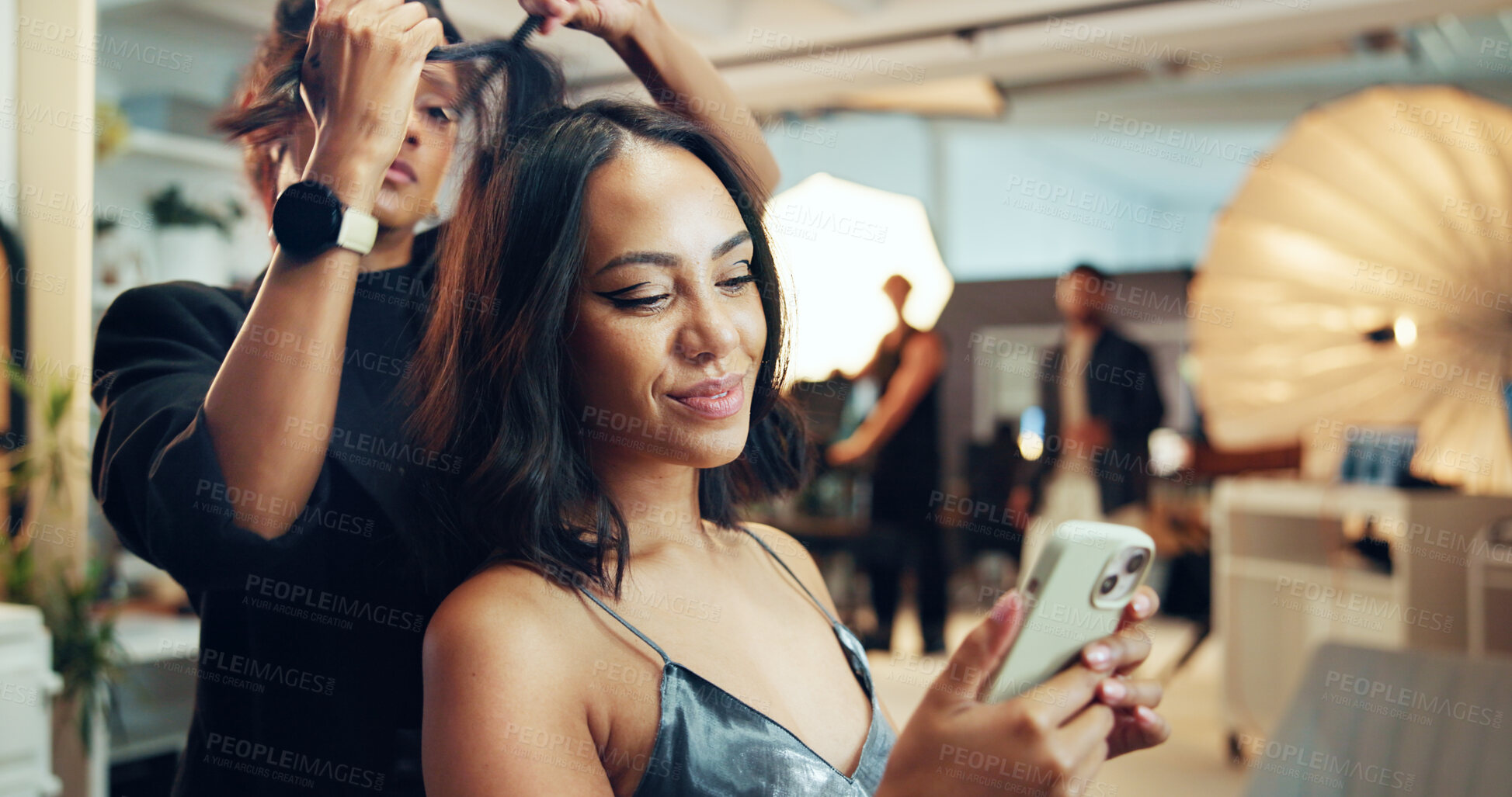 Buy stock photo Phone, photography or social media with hair stylist and model in studio for behind the scenes preparation. App, communication and getting ready with woman on set for catalog or magazine photoshoot