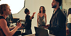 Photographer, team and model with people in studio for behind the scenes, planning and production. Discussion, backstage and creative director with group on set for photoshoot, idea and magazine