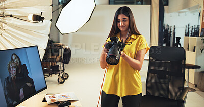 Buy stock photo Choice, photographer and woman with camera, creative and post production in studio with documents. Photography, artist and person with pictures for decision, smile and review of tech for magazine