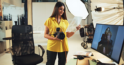 Buy stock photo Choice, photographer and woman with pictures, camera and post production in studio with documents. Photography, artist and person with photo for decision, smile and review of paperwork for magazine