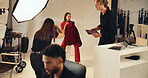 Photoshoot, photographer and model in studio, creative and pictures for fashion magazine or production. Backstage, people and group with project for media agency, camera and equipment for photography