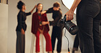 Hands, photographer and people in backstage, camera and pictures for fashion magazine and studio. Production, photoshoot and group with project for media agency, creative or equipment for photography