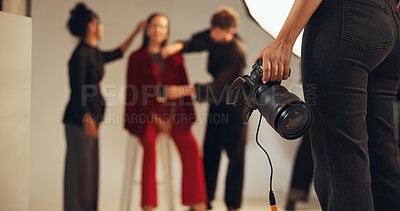 Buy stock photo Hands, photographer and people in backstage, camera and pictures for fashion magazine and studio. Tech, photoshoot and group with project for media agency, creative or equipment in behind the scenes