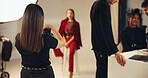 Woman, photographer and camera of photoshoot in studio of photography, casting and backstage. Director, model posing and teamwork of filming production, capture image and catalog of creative industry