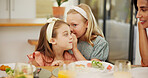 Kids, food and girl with gossip whisper at lunch for sibling privacy, confidential information or mother listening. Family, people or sister with mystery news in home for rumor, trust or healthy meal