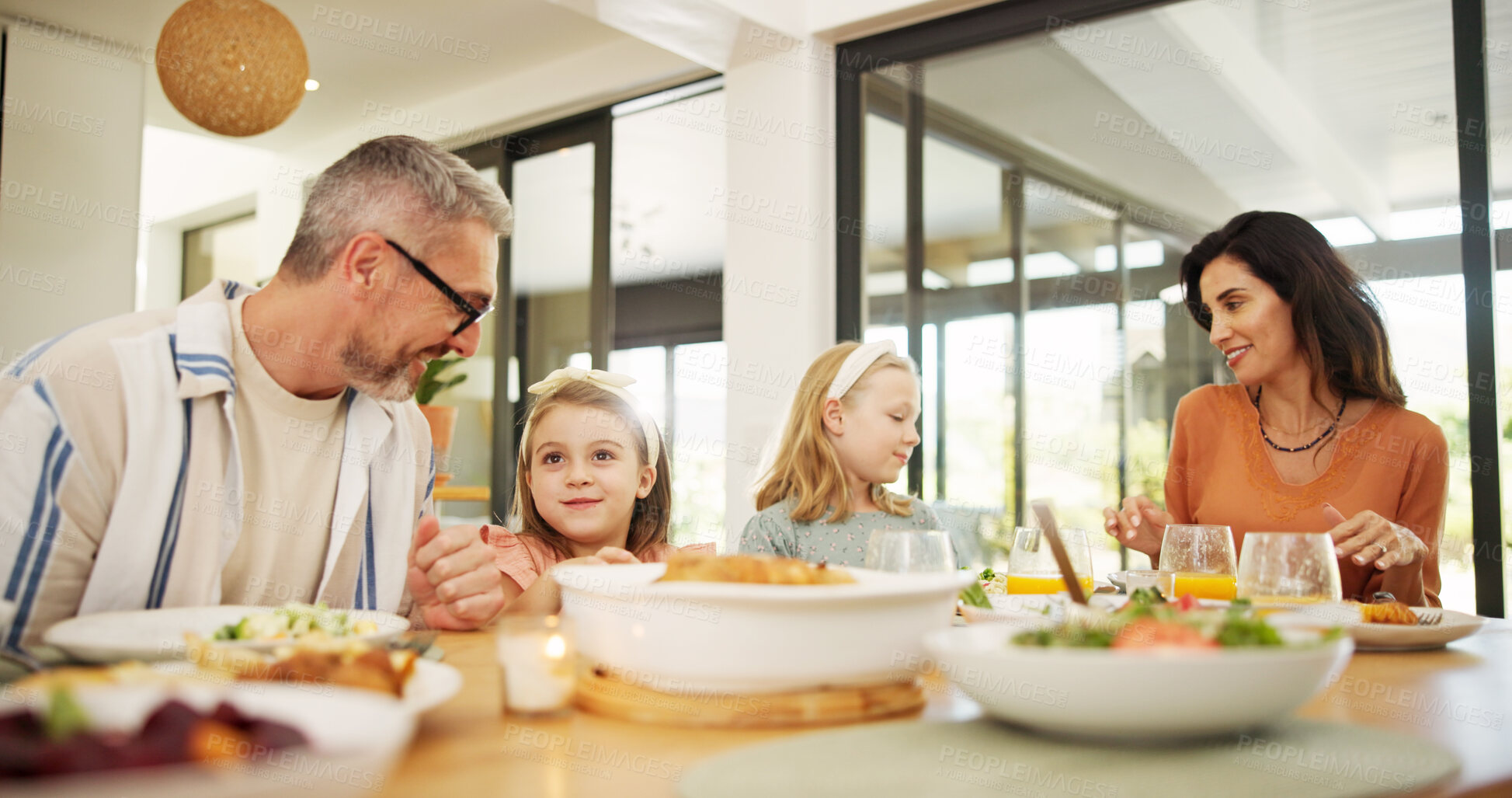 Buy stock photo Parents, children and eating food at house for lunch, healthy meal and bonding together. Smile, family and kids at dining table to dish salad for wellness, nutrition and diet vegetables for brunch