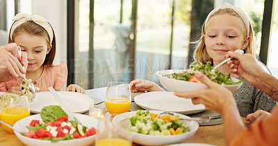 Buy stock photo Eating, food and parents with children in home for lunch, dinner and meal together for bonding. Family, happy and mother with girls at dining table to dish salad for wellness, health and nutrition